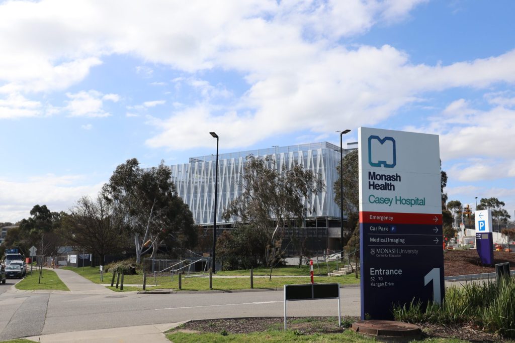 Monash Health Casey Hospital entrance sign with the carpark behind